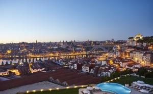a view of a city at night with a bridge at The Yeatman in Vila Nova de Gaia