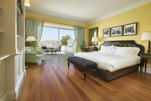 a bedroom with a large bed and a living room at The Yeatman in Vila Nova de Gaia