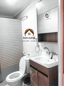 a bathroom with a toilet and a sink at RUM ALIENA LUXURY CAMP in Wadi Rum