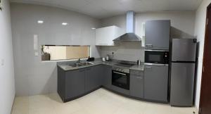 a kitchen with a refrigerator and a sink at Elegant 3-Bed room Sea-View in Muscat