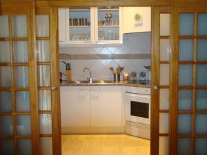 a kitchen with white cabinets and a sink at Tejo Apartment in Lisbon