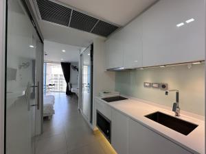 a kitchen with a sink and a counter top at Sands Condo Studio 73 by ThaiminatorPattaya in Pattaya South