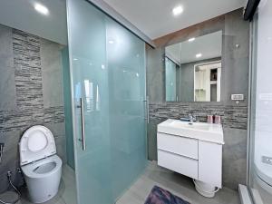 a bathroom with a toilet and a sink and a shower at Sands Condo Studio 73 by ThaiminatorPattaya in Pattaya South +9 photos
