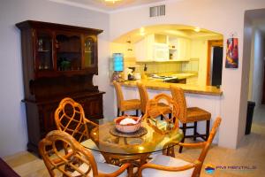 a kitchen with a table and chairs in a room at Marina Pinacate Villa-12 in Puerto Peñasco