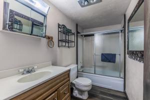 a bathroom with a sink and a toilet and a shower at Rustling Pines in Ruidoso +40 photos