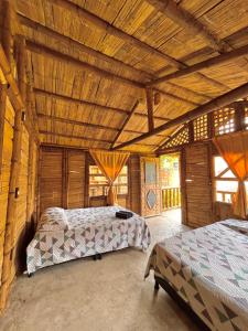 Cabañas Los Pomarrosos في Utica: غرفة نوم بسريرين وسقف خشبي