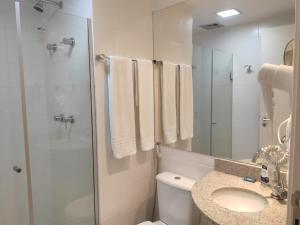 a bathroom with a shower and a toilet and a sink at Vision Diária Brasil 06908 in Brasilia