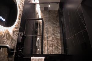 a bathroom with a shower and a mirror at 115 Luxury Suite - Privitera in Grammichele