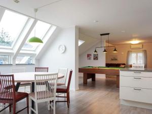 a kitchen and dining room with a table and ping pong ball at Holiday home HUNNEBOSTRAND XIII in Hunnebostrand