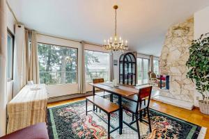 a dining room with a table and a large window at Pacific Prairie in Woodinville