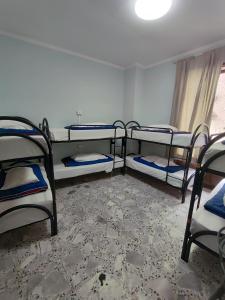 a room with three bunk beds and a window at Hello Naples in Naples
