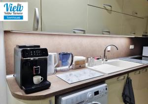 a kitchen with a coffee maker on a counter at The View Veliko Tarnovo Townhouse in Veliko Tŭrnovo