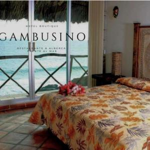 a bedroom with a bed in front of a window at Hotel Gambusino in Lázaro Cárdenas
