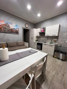 a kitchen with a table and chairs in a room at Mary House Apartments in Catania