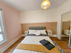 a bedroom with a bed with a stuffed animal on it at Ottawa Downtown Cozy Guesthouse in Ottawa