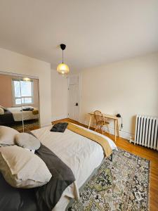 a bedroom with a large bed and a table at Ottawa Downtown Cozy Guesthouse in Ottawa