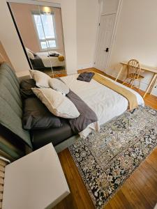 a bedroom with a large bed and a rug at Ottawa Downtown Cozy Guesthouse in Ottawa
