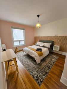 a bedroom with a large bed and a rug at Ottawa Downtown Cozy Guesthouse in Ottawa