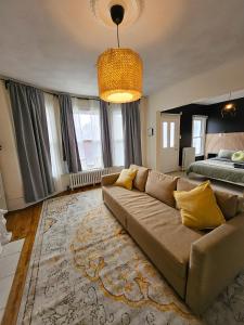 a living room with a couch and a bed at Ottawa Downtown Cozy Guesthouse in Ottawa