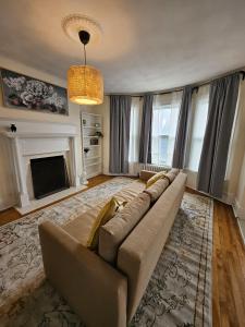 a living room with a couch and a fireplace at Ottawa Downtown Cozy Guesthouse in Ottawa