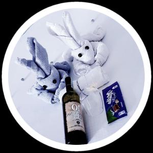 a white plate with stuffed animals and a bottle of wine at Apartment Sekulic in Doboj