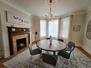 a dining room with a table and chairs and a fireplace at Ottawa Downtown Cozy Guesthouse in Ottawa +37 photos