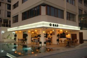 a building with a pool in front of a restaurant at Qinn Hotel in Antalya