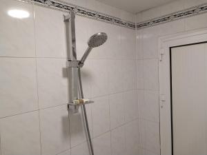 a shower with a shower head in a bathroom at KING Hostel in Center in Baku