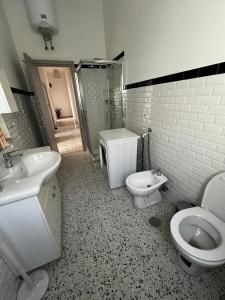 a bathroom with a sink and a toilet and a shower at Mari & Monti Affittacamere in Sapri