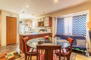 a kitchen and a living room with a table and chairs at Walk-in Eagles Nest Condo with Pool and Hot Tub near Silver Dollar City in Branson