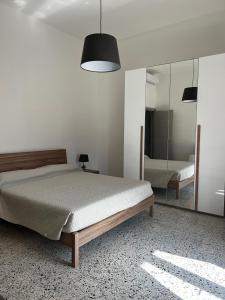 a bedroom with a bed and a mirror at Mari & Monti Affittacamere in Sapri