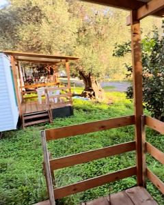 a fence in a yard with a bar in the background at Sunrise Village Cilento in Pisciotta