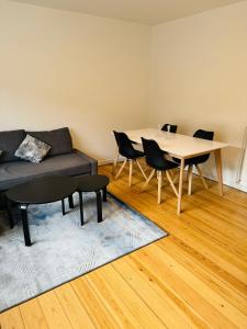 a living room with a couch and a table and chairs at Cozy Apartment Aarhus C in Aarhus