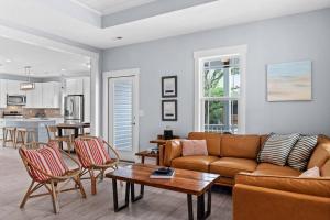a living room with a couch and a table at Live Oak Villa~OKI Beach Retreat in Oak Island
