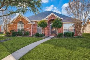 a brick house with a sidewalk in front of it at Frisco Spacious & Cozy Bling Home by Aya in Frisco