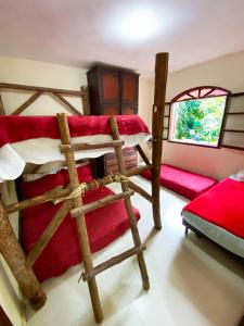 a bedroom with three bunk beds in a room at Green House saqua in Saquarema