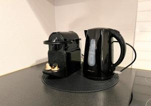 a black coffee maker sitting on top of a counter at Le Charme D'Antan in Évreux