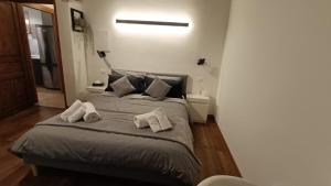 a bedroom with a bed with two towels on it at Mina Home in Gorizia