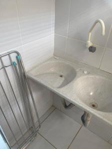 a bathroom with a sink and a faucet at Apto "Cantinho da Paula" in Maragogi