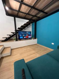 sala de estar con sofá y TV en Da Lello: Luxury Loft strategico en Marigliano
