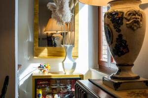 a vase sitting on a table next to a refrigerator at Villa Elvira 1931 in Siena