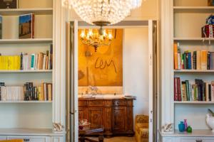 a chandelier in a room with bookshelves at Villa Elvira 1931 in Siena +185 photos