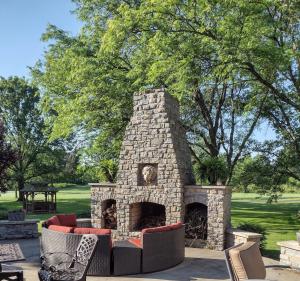 a stone fireplace with couches in a park at Golf Course Home - New Listing in Mason