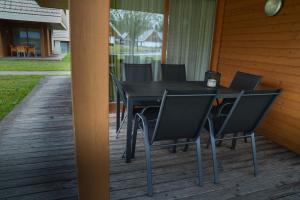 a black table and chairs on a porch at Apartma Pikabooth Terme Topolšica in Topolšica
