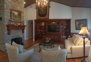 a living room with a couch and a tv at Golf Course Home - New Listing in Mason