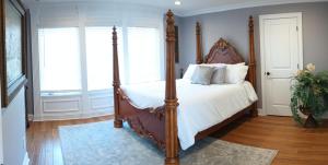 a bedroom with a large bed with a wooden frame at Golf Course Home - New Listing in Mason