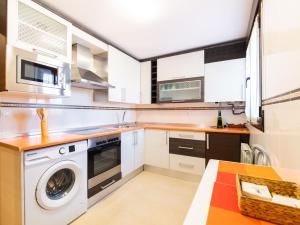 a kitchen with a washer and a washing machine at Apartamento "MARINA" in Tordesillas +2 photos