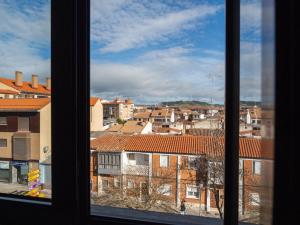 a view of a city from a window at Apartamento "MARINA" in Tordesillas