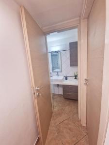 a bathroom with a sink and a mirror and a door at Casa vacanza Castello in Cagliari +31 photos