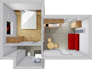 Vista funcional de una cocina con puerta roja en Sandhof, en Termeno